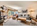 Cozy living room with stone fireplace, comfortable seating, and large windows at 755 Columbine Rd # 303, Breckenridge, CO 80424