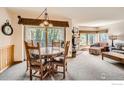 Open-concept living and dining room with stone fireplace and view to the outside at 755 Columbine Rd # 303, Breckenridge, CO 80424
