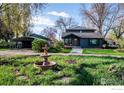 Charming home featuring a lovely fountain and well-maintained lawn at 7800 Hygiene Rd, Longmont, CO 80503