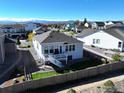 Backyard view of the home, featuring a deck, fenced yard, and mountain views in the distance at 790 Lowrey Ln, Berthoud, CO 80513