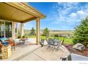 Enjoy outdoor living on this covered patio with views of a beautiful backyard at 82 Rivera Ct, Erie, CO 80516