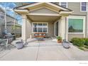 Covered patio with seating area; ideal for relaxation and enjoying the outdoors at 82 Rivera Ct, Erie, CO 80516