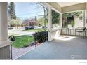 Spacious front porch featuring neutral tiling and comfortable seating with a view of the street at 1013 4Th Ave, Longmont, CO 80501