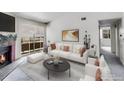 Bright living room features a fireplace, modern decor, and a seamless flow to adjacent spaces at 1094 S Dearborn St # 301, Aurora, CO 80012