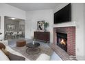 Comfortable living room with fireplace and adjacent dining area at 1094 S Dearborn St # 301, Aurora, CO 80012