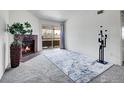Cozy living room featuring a brick fireplace, sliding glass door to the balcony, and stylish decor at 1094 S Dearborn St # 301, Aurora, CO 80012