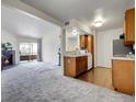 Open concept living room with hardwood floors that adjoins the kitchen and has access to the balcony at 1094 S Dearborn St # 301, Aurora, CO 80012