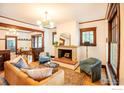 Warm and inviting living room with a stone fireplace, hardwood floors, and lots of natural light at 1114 5Th Ave, Longmont, CO 80501