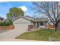 Inviting single-Gathering home featuring a well-manicured lawn and a two-car garage at 11296 Daisy Ct, Firestone, CO 80504