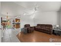 Open-concept living room with vaulted ceilings and easy access to the kitchen and dining area at 11296 Daisy Ct, Firestone, CO 80504