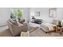 Bright living room features modern decor, comfortable seating, and large windows for natural light at 1181 Dover Way, Broomfield, CO 80020