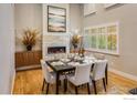 Bright dining room with modern fireplace, hardwood floors, and shuttered windows at 1231 Cedar Ave, Boulder, CO 80304