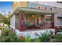 Relaxing front porch with comfortable seating, stylish decor, and manicured flower beds at 1231 Cedar Ave, Boulder, CO 80304