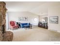 Bright living room with fireplace, plush seating, neutral walls, and carpeted floor at 1321 Madero St, Broomfield, CO 80020