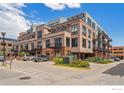 A stylish condo building with balconies, parking, and nice landscaping at 1360 Walnut St # 211, Boulder, CO 80302