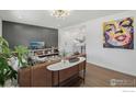 Bright living room featuring a modern leather sofa, hardwood floors, and eye-catching artwork at 1575 Findlay Way, Boulder, CO 80305