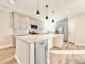 Spacious kitchen with marble island, gray cabinets, and modern appliances for a chef-inspired cooking experience at 17910 County Road 38, Platteville, CO 80651