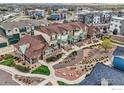 A row of townhomes with attractive landscaping and a view of the city skyline at 1831 Kalel Ln, Louisville, CO 80027