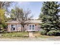 Charming single-story home surrounded by mature trees and a well-manicured lawn at 1891 Orchard Ave, Boulder, CO 80304