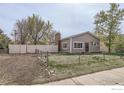 Charming single-story home with mature trees and fenced yard at 214 2Nd St, Frederick, CO 80530