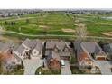 Stunning aerial view of homes backing onto a lush golf course and community at 2210 Calais Dr # B, Longmont, CO 80504