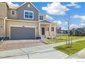 Charming two-story home with a brick driveway, covered porch, and a manicured lawn at 2260 Crescent Cir, Erie, CO 80026