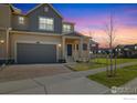 Charming two-story home with a brick driveway, covered porch, and a manicured lawn at 2260 Crescent Cir, Erie, CO 80026
