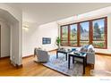 Bright living room with hardwood floors, modern furniture, and large view windows at 2499 Powderhorn Ln, Boulder, CO 80305