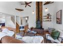 Living room with vaulted ceilings, wood beams, rustic stone fireplace, hardwood floors, and bright natural light at 251 Ridgeview Ln, Boulder, CO 80302