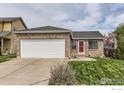 Charming brick home with a well-maintained lawn and a two-car garage at 2680 Bryant Dr, Broomfield, CO 80020