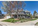 Charming two-story home featuring a welcoming front porch and well-manicured lawn on a sunny day at 2862 Flint Ct, Superior, CO 80027