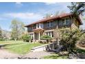 Stunning stone home with a red tile roof, lush lawn, and mature trees at 2935 19Th St, Boulder, CO 80304