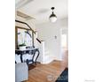 Inviting foyer with white staircase, stylish console table, and hardwood floors at 2935 19Th St, Boulder, CO 80304