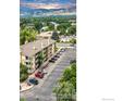Apartment complex parking lot view with mature trees at 3035 Oneal Pkwy # 19, Boulder, CO 80301