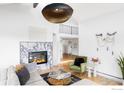 Bright living room with marble fireplace, hardwood floors, and comfortable seating at 319 S Peak Rd, Boulder, CO 80302