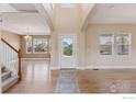 Bright entryway featuring hardwood floors, staircase, and neutral paint at 3530 Willow Rd, Frederick, CO 80504