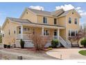 Charming yellow two-story home with a covered porch and well-kept landscaping at 3530 Willow Rd, Frederick, CO 80504