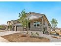 New construction home with stone accents, a covered front porch and a three-car garage, landscaping not yet complete at 4316 Gypsum Ave, Mead, CO 80504
