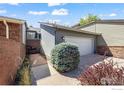 Charming home exterior shows a brick walkway and side entry with mature shrubbery at 4950 Sundance Sq, Boulder, CO 80301