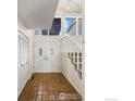 Bright foyer featuring tile floors, a staircase, and a double-door entry with decorative glass panels at 4950 Sundance Sq, Boulder, CO 80301