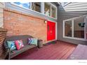 Inviting front porch with a charming seating area, a red front door, and ample natural light at 4950 Sundance Sq, Boulder, CO 80301