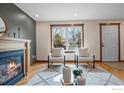 Bright living room featuring a fireplace, natural light, and modern decor at 593 Juniper Ct, Louisville, CO 80027