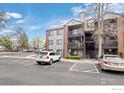 Apartment building with multiple balconies and parking space at 6385 Oak St # 301, Arvada, CO 80004