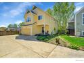 Charming two-story yellow home with a front porch, attached garage, and well-maintained landscaping at 740 Boxwood Ln, Longmont, CO 80503