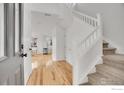 Bright foyer with hardwood floors, staircase, and open view to the living area at 740 Boxwood Ln, Longmont, CO 80503