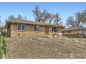 Delightful brick home featuring a well-maintained front yard with cozy outdoor seating area at 7950 Maria St, Westminster, CO 80030