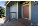 Front porch and door with wood decking and modern railing at 804 Summer Hawk Dr # 11208, Longmont, CO 80504
