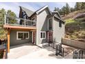 Exterior view of home with gray siding, red doors, and metal railings at 93 Pine Needle Rd, Boulder, CO 80304