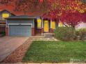 Charming home with a two-car garage, well-maintained lawn, and tree at 12948 E 106Th Way, Commerce City, CO 80022