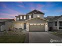 Charming two-story home featuring a two-car garage, inviting front porch, and a beautifully landscaped yard at 1312 Loraine S Cir, Lafayette, CO 80026